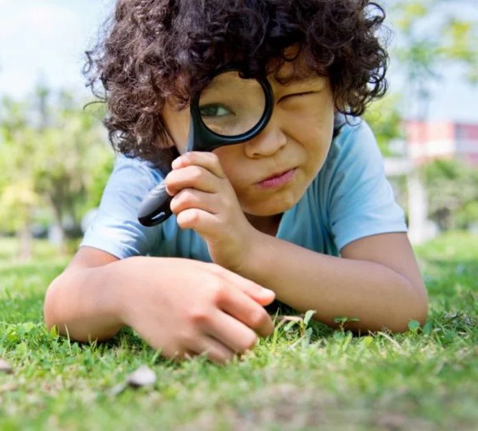 Child with a magnifying glass